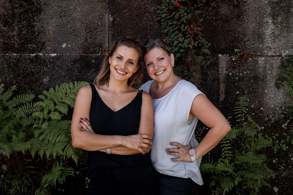 two wedding stylists smiling at camera